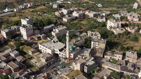 aerial view of a middle eastern village with a central mosque