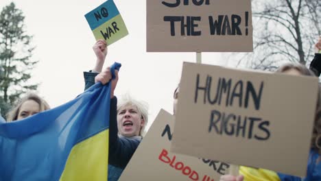 group of young caucasian people manifesting against ukrainian war.