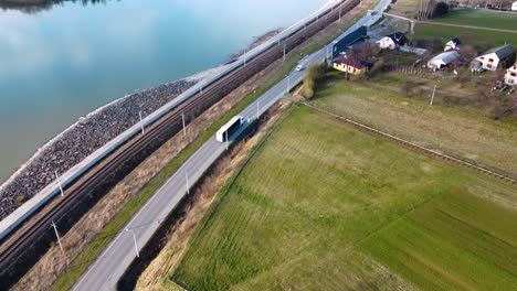 Drone-following-truck-next-to-the-lake