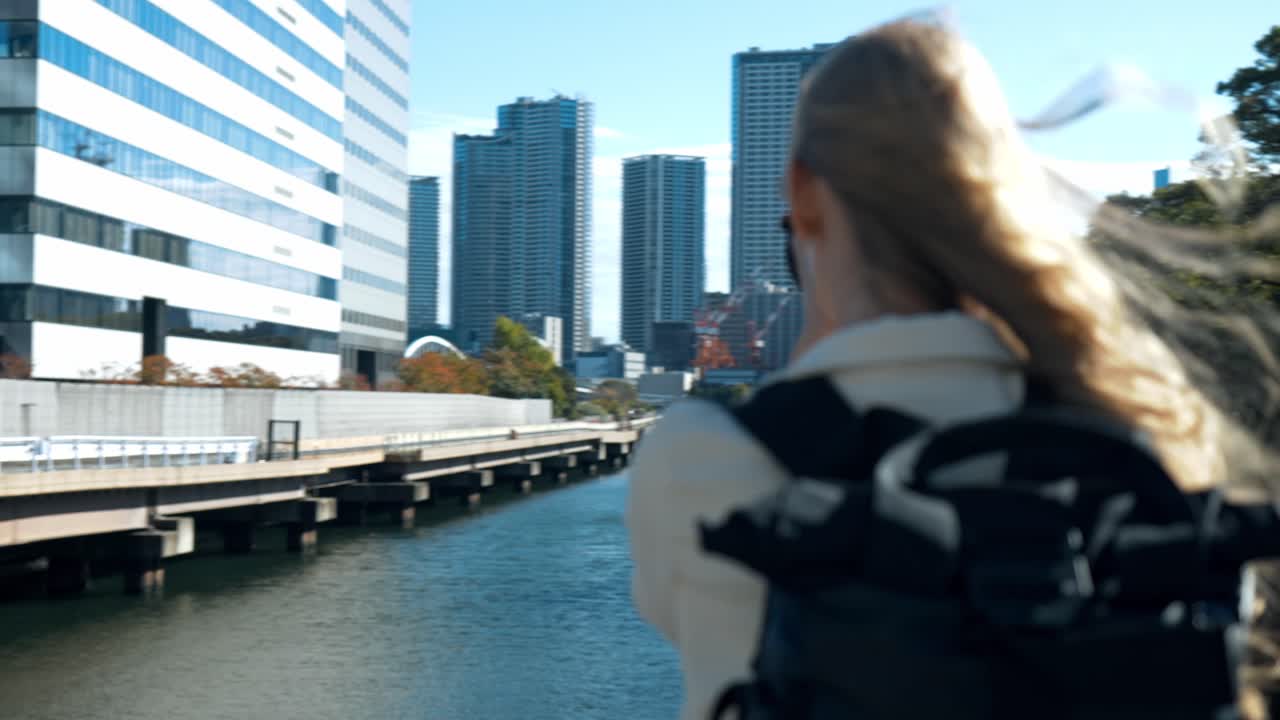 A serene shot of a photographer immersed in capturing the beauty of Hamarikyu Gardens in Tokyo.