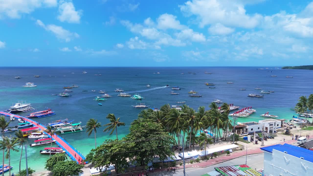 Beautiful 4K drone shot of Boracay’s iconic floating dock, palm trees, and boats on turquoise water—perfect for travel and island lifestyle projects