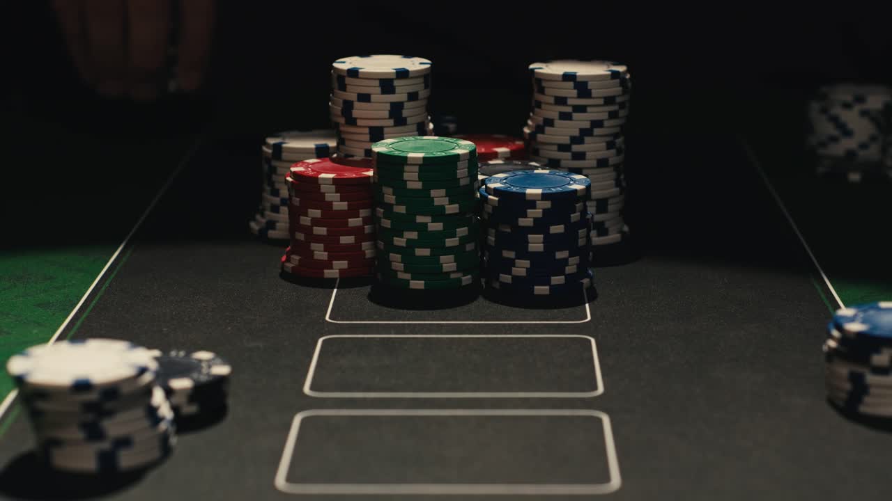 Hands managing poker chips on green table, reflecting intense poker gameplay with the element of chance and skill