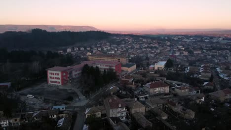 Aerial-shot-of-a-high-school-in-Veliki-Preslav,-Bulgaria-at-sunset