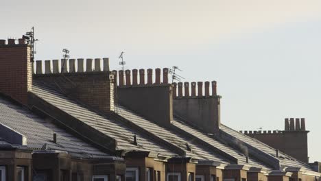 Vintage Tenement Chimneys in Golden Hour with Frosty Roofs