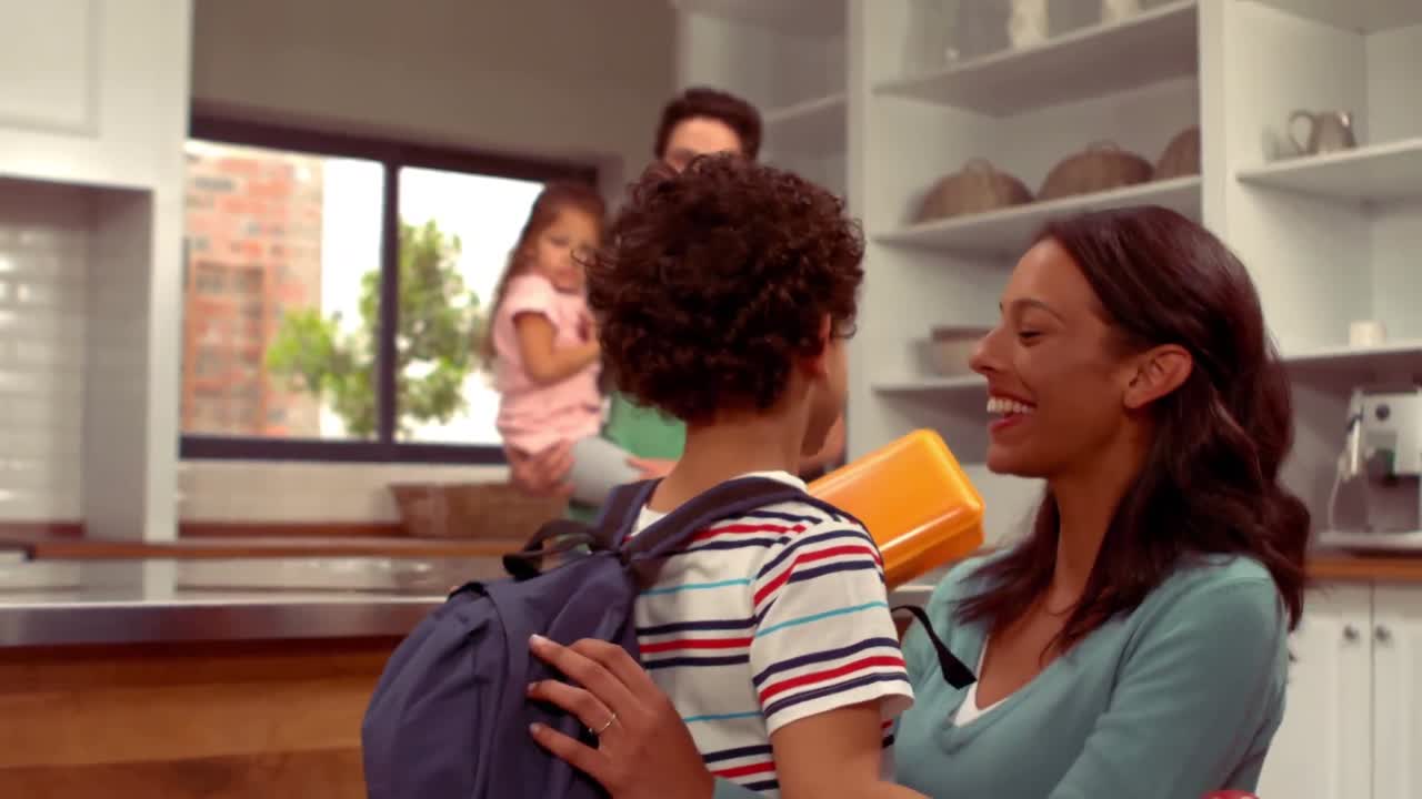 Smiling Hispanic boy saying goodbye to his family