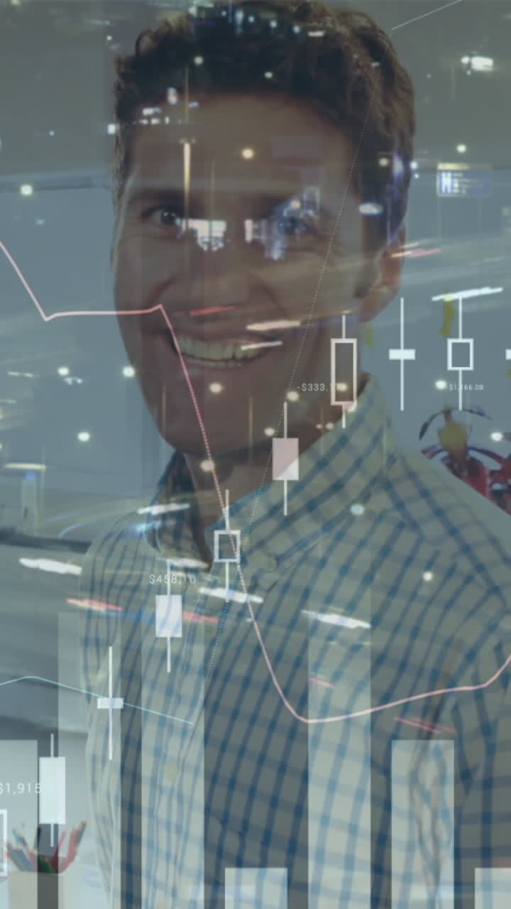 Composite video of statistical data processing against portrait of caucasian man smiling at office