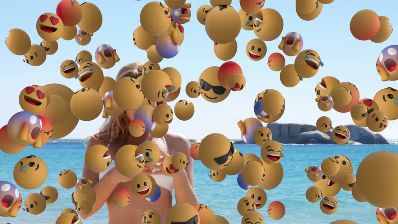 At beach, person using smartphone with floating smiling emojis animation