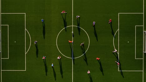 aerial view of a soccer match in progress: players strategically position themselves on the field, highlighting the dynamics of team play and competition