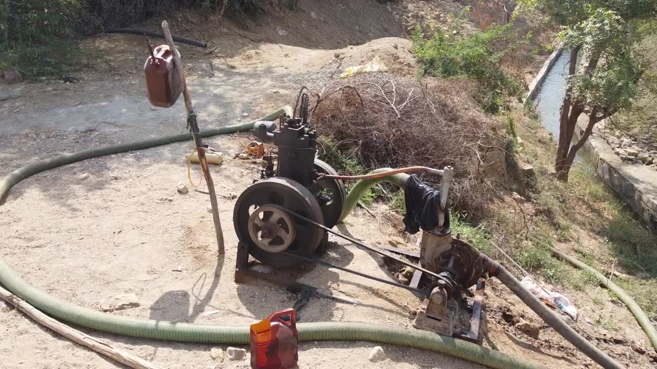Water pump engine used in agriculture is pumping water to farms  from water canal in villages