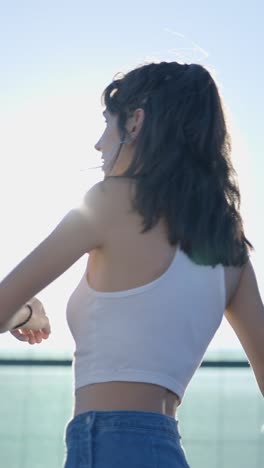 woman in bright sunlight smoking a cigarette