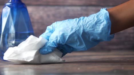 cleaning a surface with gloves and a cleaning cloth