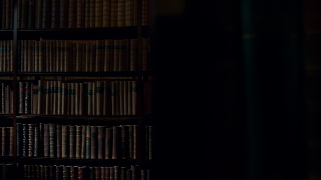 Person With Headphones In Library, Walking Past Leatherbound Shelves Under Vaulted Ceiling, Warm Low Light,