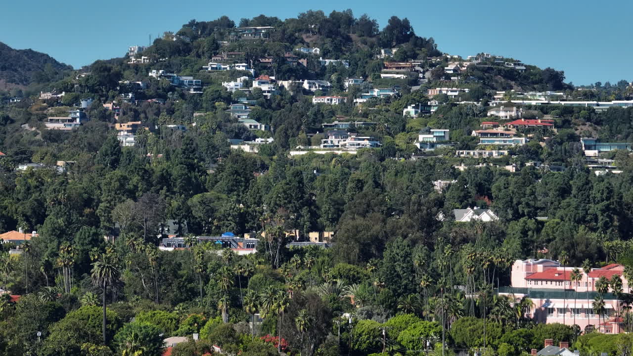 Aerial tracking shot in front of hillside houses in the San Fernando valley, LA