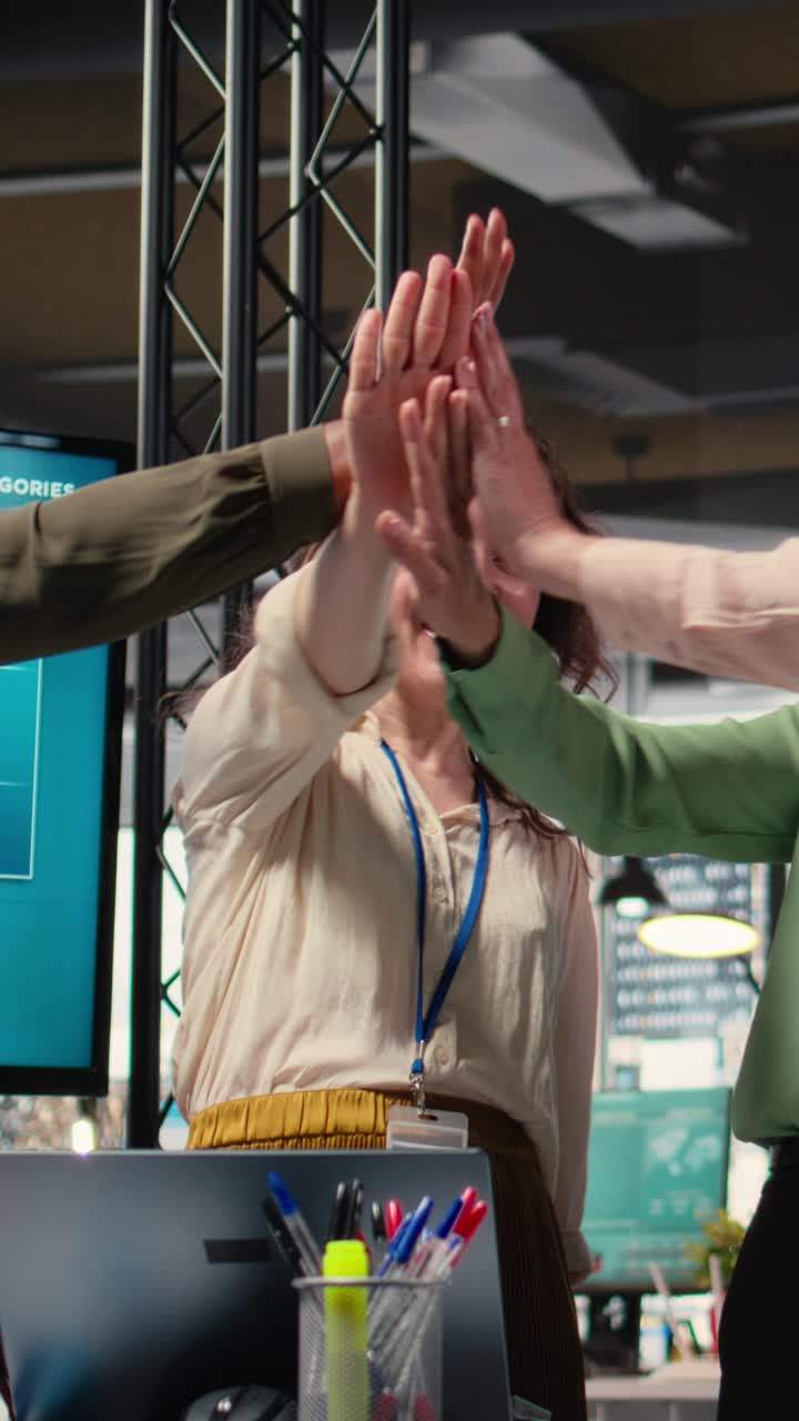 Vertical Video Group of corporate women working on data analysis and setting project goals