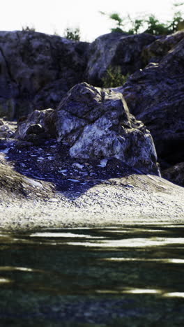calm water gently laps against rocky shoreline at sunset hour