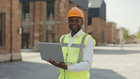 engineer using a laptop on a construction site
