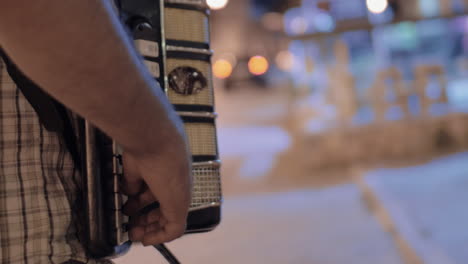 Man-playing-accordion-in-the-street-and-earning-money