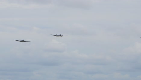 two silver and blue douglas dc3 performs at baltic international airshow, carrying out flypast, view from the ground, handheld 4k shot