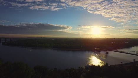 Silhouette-Prince-Vladimir-holding-cross-in-evening-Kiev-aerial-landscape