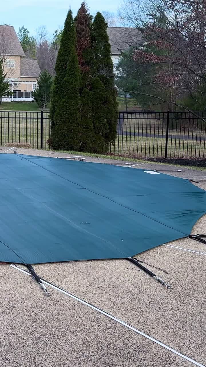 Closed swimming pool secured for winter in a quiet neighborhood, Vertical tilting view