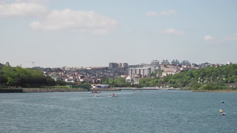 city river scene with rowing boats