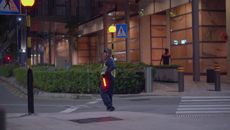 night traffic controller at crosswalk