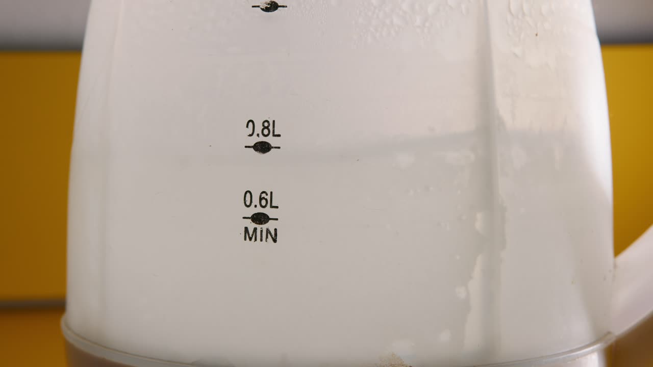 Close-up of water reaching a boiling state in a thermo pot. The shot captures the bubbling water and evokes a warm, cozy atmosphere