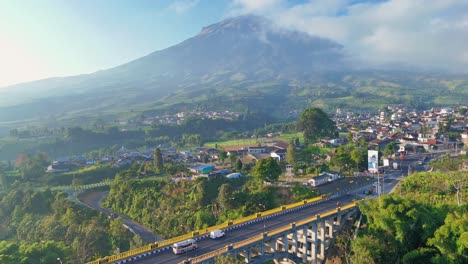 aerial view of a town and volcano in indonesia