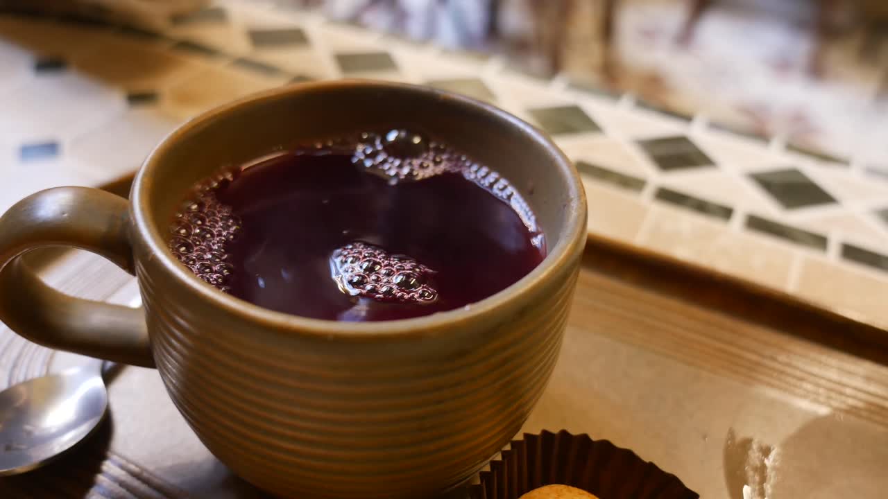 Hand Picking Up a Warm Drink from a Ceramic Cup