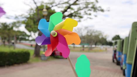 pinwheel rotates rapidly in a breezy park setting.