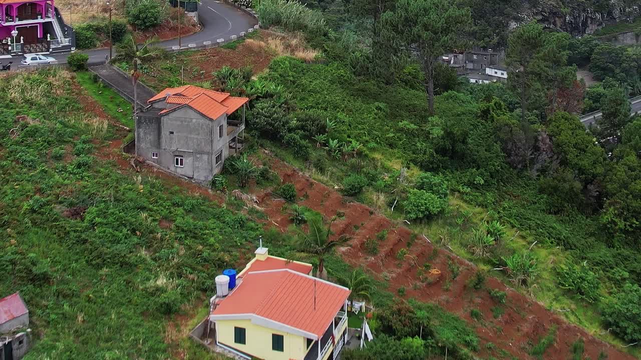 Scenic aerial view of green fields and houses in Madeira, Portugal