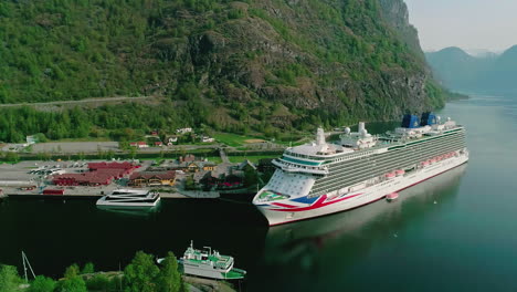 Large-cruise-ship-yachts-and-fishing-boats-docked-at-the-shore-Norway-flam-pan-shot-right-to-left