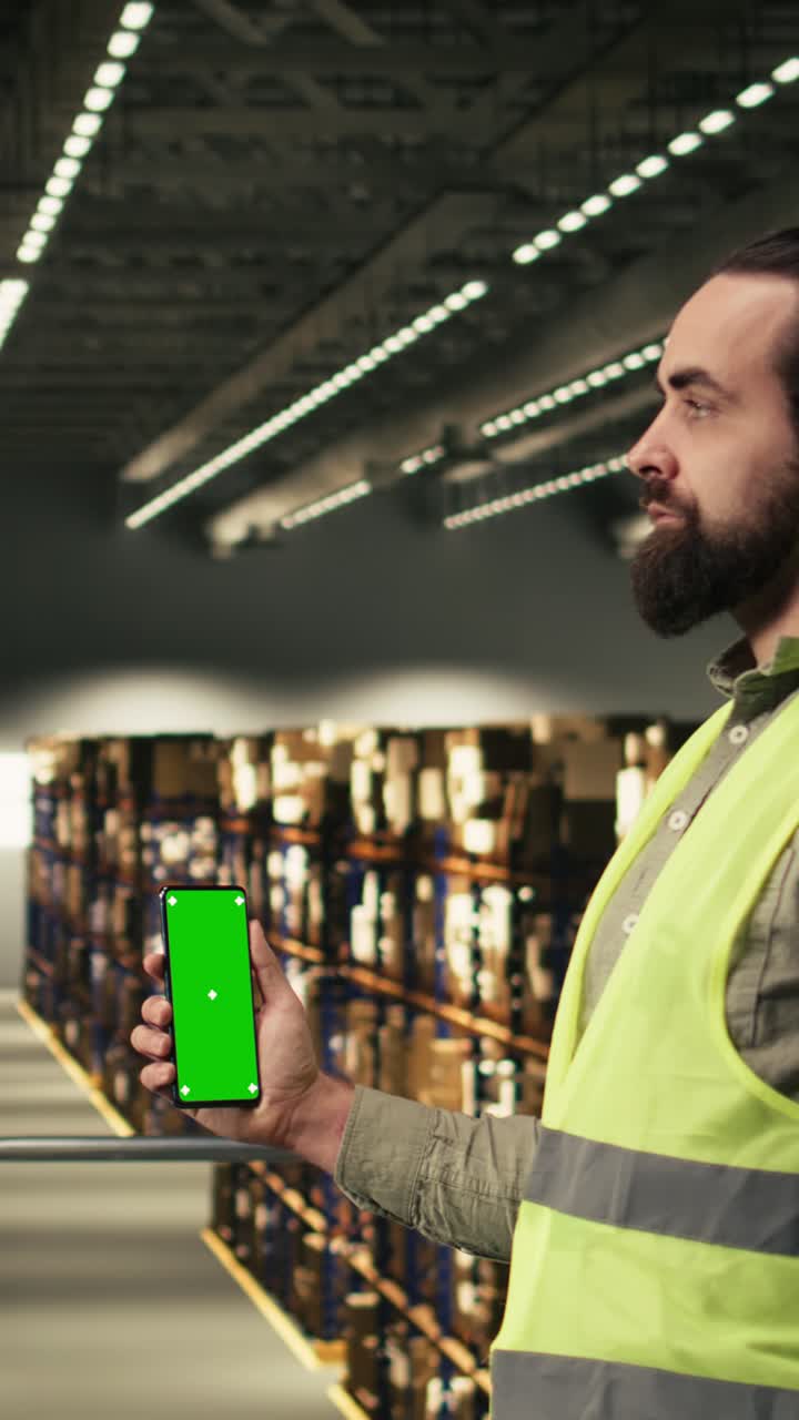 Vertical Video Vertical green screen phone near distribution workforce handling packages