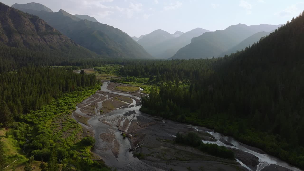 Scenic aerial view of a serene river and lush green valley at sunrise