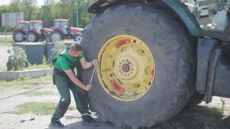 farmer mechanic repairing tractor. open tractor hood, engine. repair agricultural technology