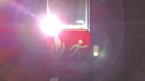 Exit emergency sign in 4K with glowing sun flare from window