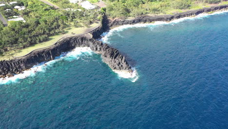 aerial view over the lava rock formation of cap mechant and the coastline of reunion island