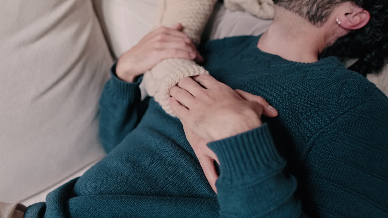 Gay Couple Cuddling on the Couch at Home