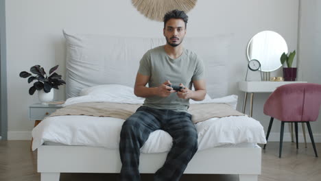 Man Playing Video Games in Bedroom