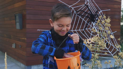 portrait of boy in fancy dress werewolf costume outside house collecting candy for trick or treat