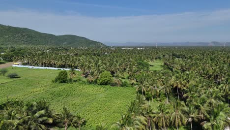 High-angle-shot-of-the-highway-passing-through-scenic-countryside-with-green-fields-and-villages