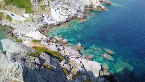 panning downwards shot of tourists walking away from thestunning agios ioannis kastri that appeared in mamma mia