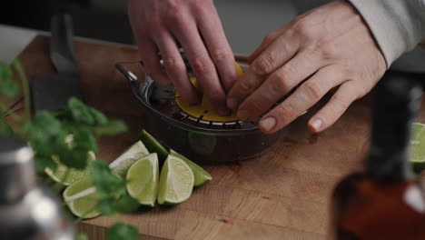 Young-male-placing-bit-on-top-of-the-lemon-press-in-slow-motion