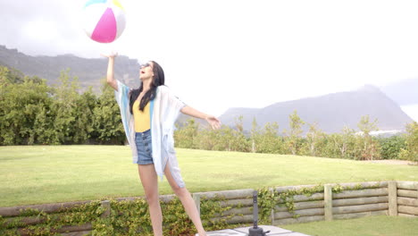 a young biracial woman dances joyfully outdoors in the backyard at home, copy space