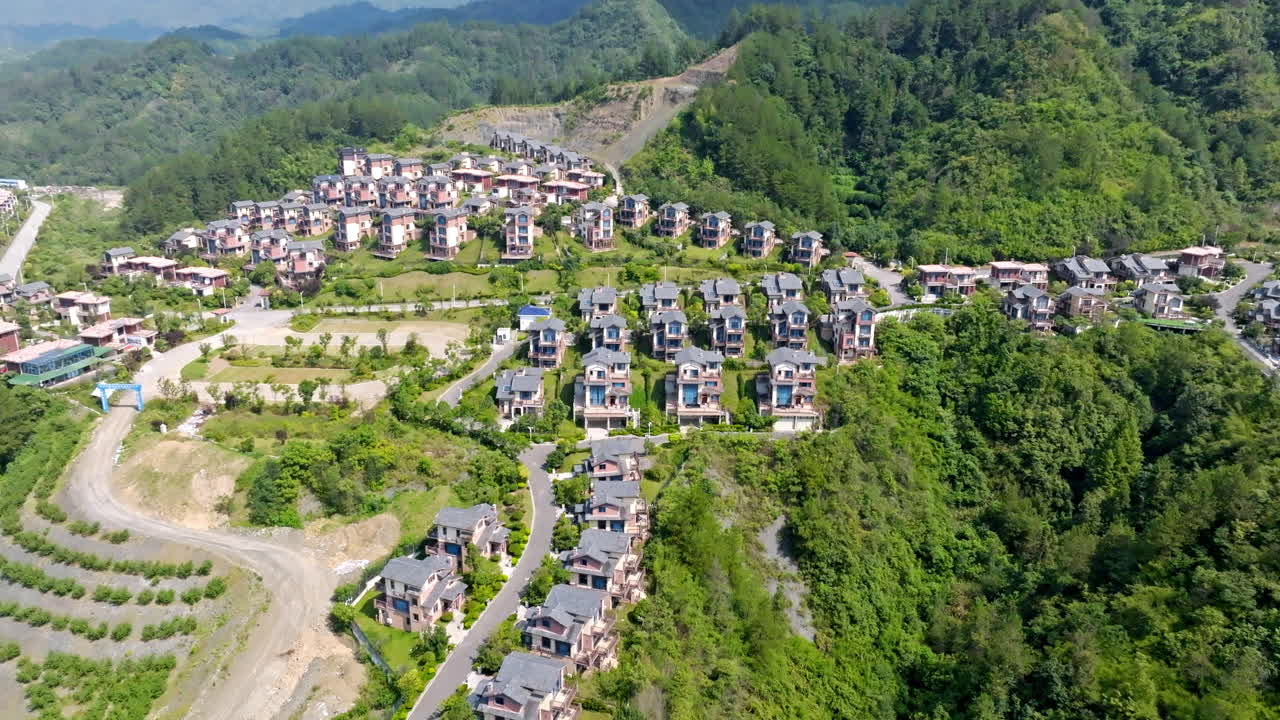 Aerial view approaching hillside holiday homes, sunny, summer day in China