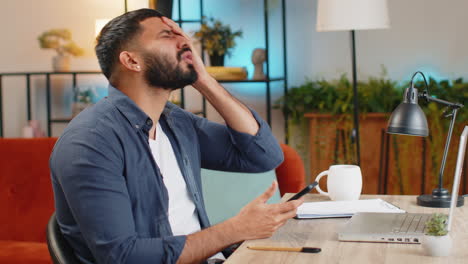 indian man using smartphone browsing loses bad news, fortune loss fail at home office desk workplace