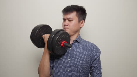 middle shot asian office worker, man lifting dumbbell gymnastics in office clothes