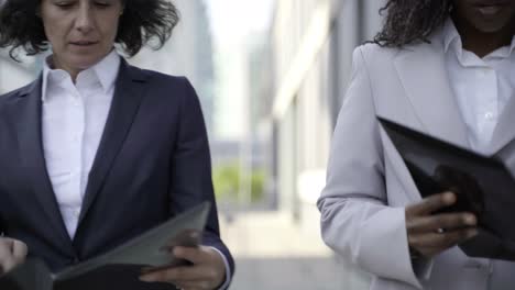 multiethnic businesswomen holding folders