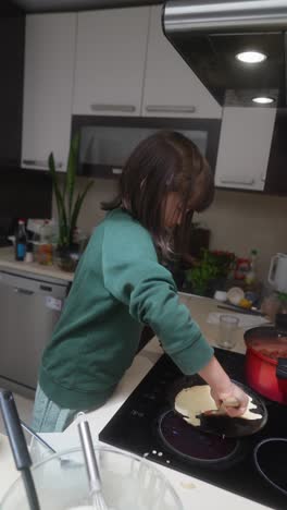 little girl cooking pancakes