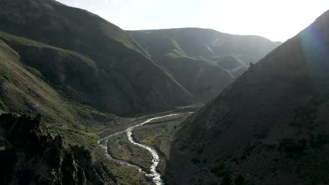 aerial view of the campanario river in the maule region of chile at dawn with the arid mountains of the central zone